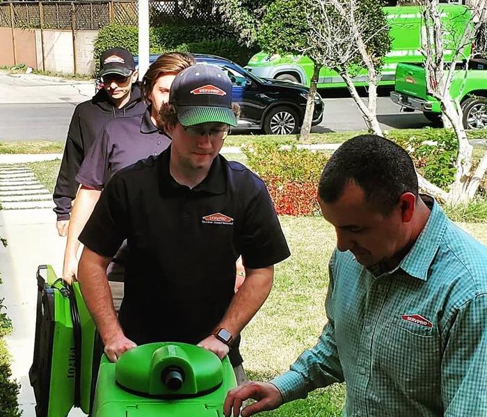 SERVPRO crew on a job with equipment
