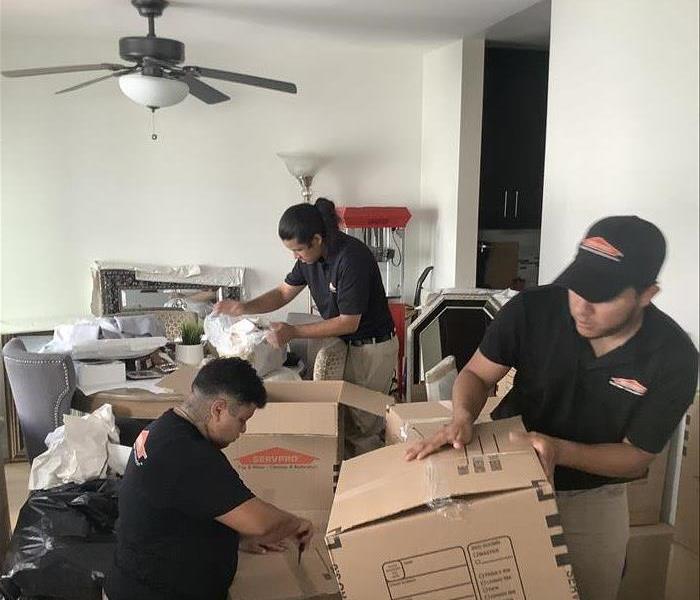 Team members performing a pack out service. 